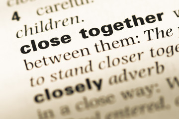 Close up of old English dictionary page with word close together