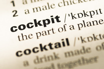 Close up of old English dictionary page with word cockpit