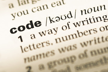 Close up of old English dictionary page with word code