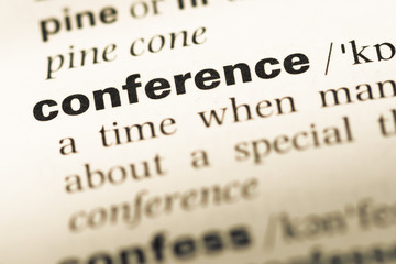 Obraz premium Close up of old English dictionary page with word conference