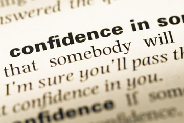 Obraz premium Close up of old English dictionary page with word confidence in