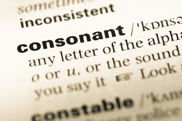 Obraz premium Close up of old English dictionary page with word consonant