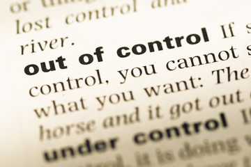 Obraz premium Close up of old English dictionary page with word out of control