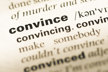 Obraz premium Close up of old English dictionary page with word convince