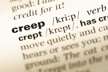 Fototapeta premium Close up of old English dictionary page with word creep