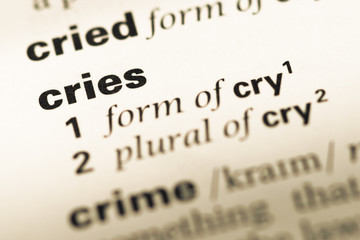 Obraz premium Close up of old English dictionary page with word cries