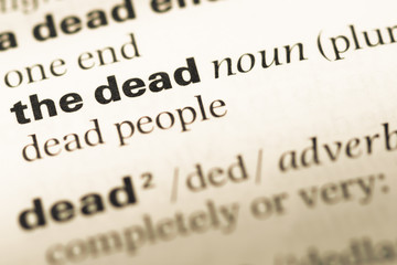 Close up of old English dictionary page with word the dead