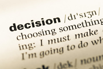 Obraz premium Close up of old English dictionary page with word decision