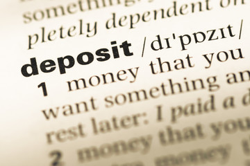 Fototapeta premium Close up of old English dictionary page with word deposit