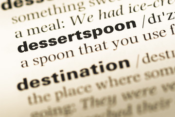 Fototapeta premium Close up of old English dictionary page with word dessertspoon