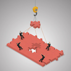 A business team building a puzzle jigsaw. Teamwork business conc