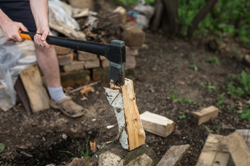 man chopping wood in village