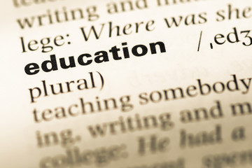 Fototapeta premium Close up of old English dictionary page with word education