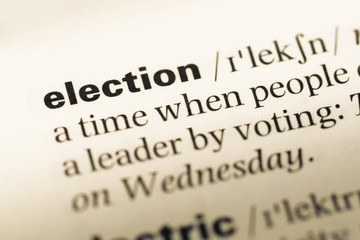 Obraz premium Close up of old English dictionary page with word election