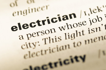 Obraz premium Close up of old English dictionary page with word electrician