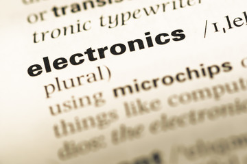Close up of old English dictionary page with word electronics