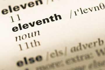 Close up of old English dictionary page with word eleventh