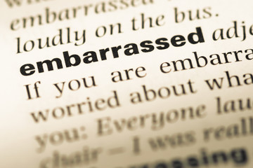 Fototapeta premium Close up of old English dictionary page with word embarrassed