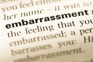 Close up of old English dictionary page with word embarrassment