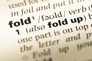 Obraz premium Close up of old English dictionary page with word fold