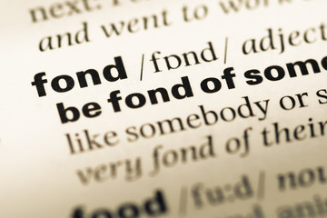 Obraz premium Close up of old English dictionary page with word fond