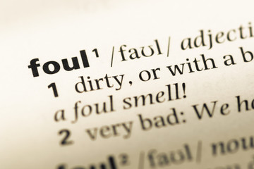 Obraz premium Close up of old English dictionary page with word foul
