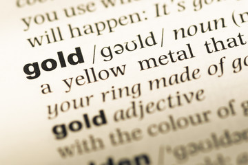 Obraz premium Close up of old English dictionary page with word gold