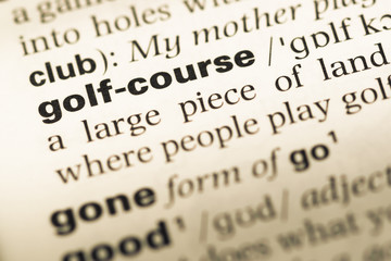 Close up of old English dictionary page with word golf course