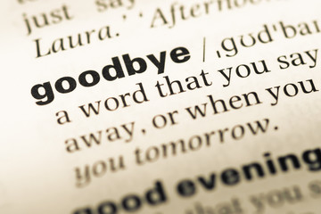 Close up of old English dictionary page with word goodbye
