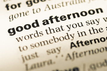 Close up of old English dictionary page with word good afternoon