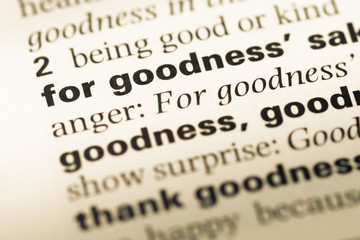 Close up of old English dictionary page with word for goodness