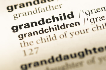 Close up of old English dictionary page with word grandchild
