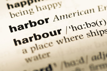 Close up of old English dictionary page with word harbor