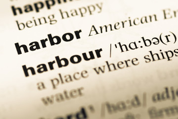 Fototapeta premium Close up of old English dictionary page with word harbor