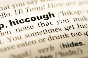 Fototapeta premium Close up of old English dictionary page with word hiccough