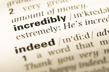 Fototapeta premium Close up of old English dictionary page with word incredibly