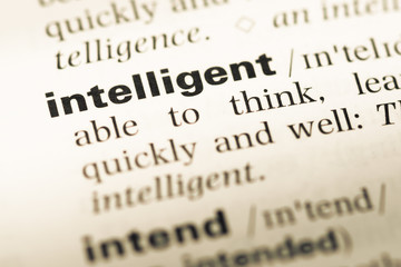 Obraz premium Close up of old English dictionary page with word intelligent