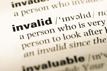 Fototapeta premium Close up of old English dictionary page with word invalid