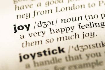 Fototapeta premium Close up of old English dictionary page with word joy