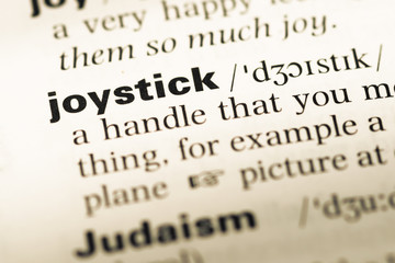 Close up of old English dictionary page with word joystick