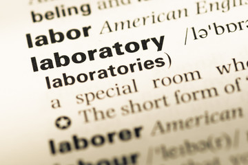 Obraz premium Close up of old English dictionary page with word laboratory