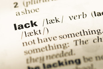 Close up of old English dictionary page with word lack