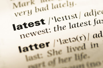 Fototapeta premium Close up of old English dictionary page with word latest