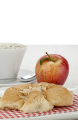 almond croissant served with cappuccino and apple