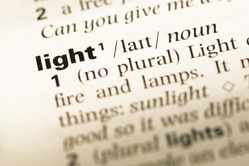 Fototapeta premium Close up of old English dictionary page with word light