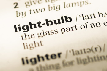 Close up of old English dictionary page with word light bulb