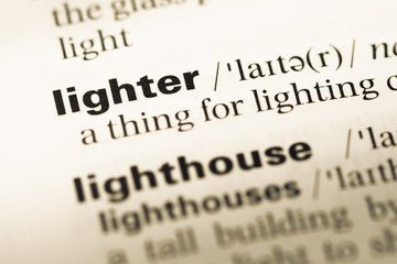 Close up of old English dictionary page with word lighter
