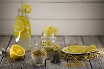 Obraz na płótnie Canvas lemon, lemonade , cane sugar on wooden background