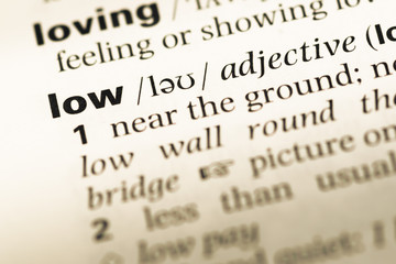 Fototapeta premium Close up of old English dictionary page with word low