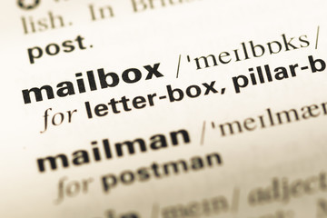 Obraz premium Close up of old English dictionary page with word mailbox